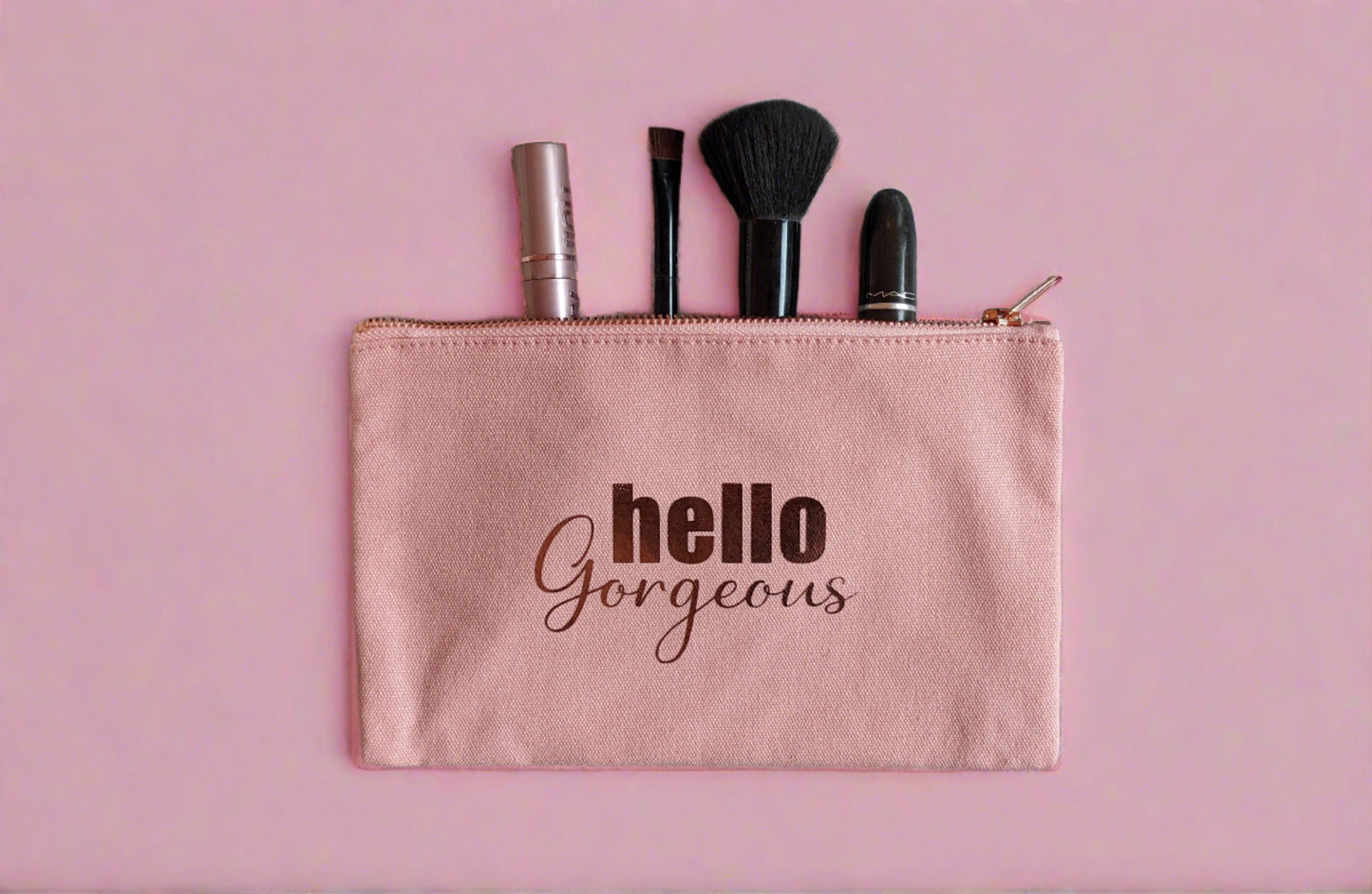 pink rectangle make up bag with rose gold zip, waterproof internal lining and the words Hello Gorgeous in rose gold on the front https://wattlelanedesigns.com.au/products/hello-gorgeous-make-up-bag