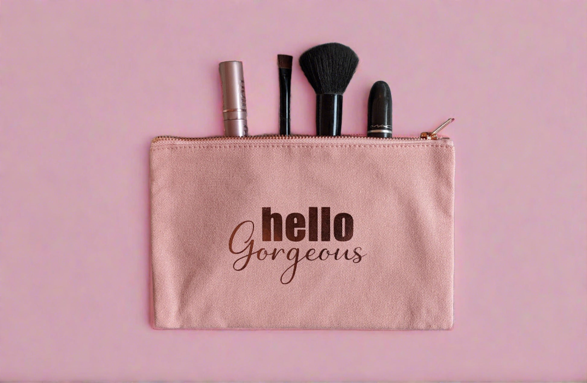 pink rectangle make up bag with rose gold zip, waterproof internal lining and the words Hello Gorgeous in rose gold on the front  https://wattlelanedesigns.com.au/products/hello-gorgeous-make-up-bag