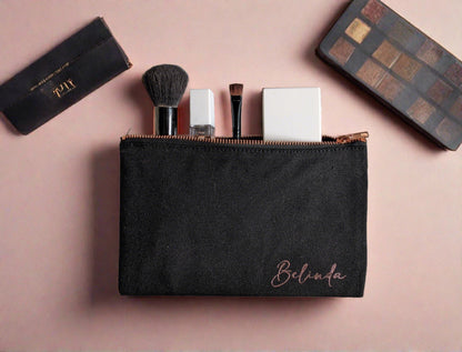 black rectangle shaped makeup case with rose gold zip, waterproof internal lining and personalised with a name in rose gold in bottom right hand corner  https://wattlelanedesigns.com.au/products/personalised-make-up-bag