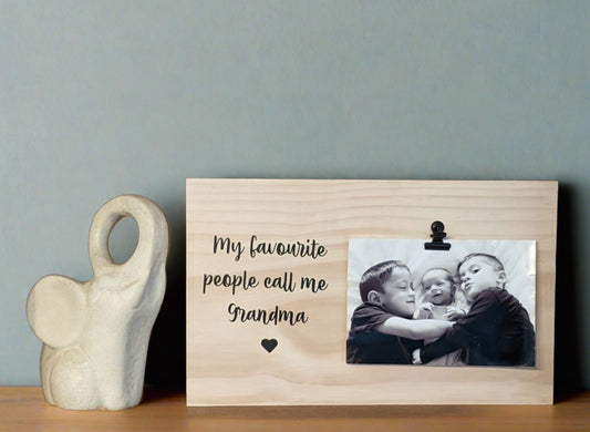 A wooden photo plaque with a black bulldog clip, personalized with the text 'My Favourite People Call Me...'. personalised how you like
